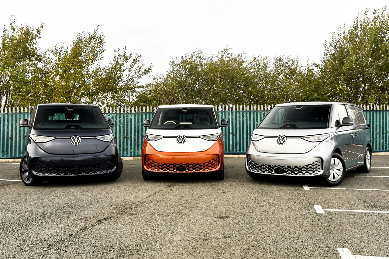 three electric vehicles parked in a parking lot