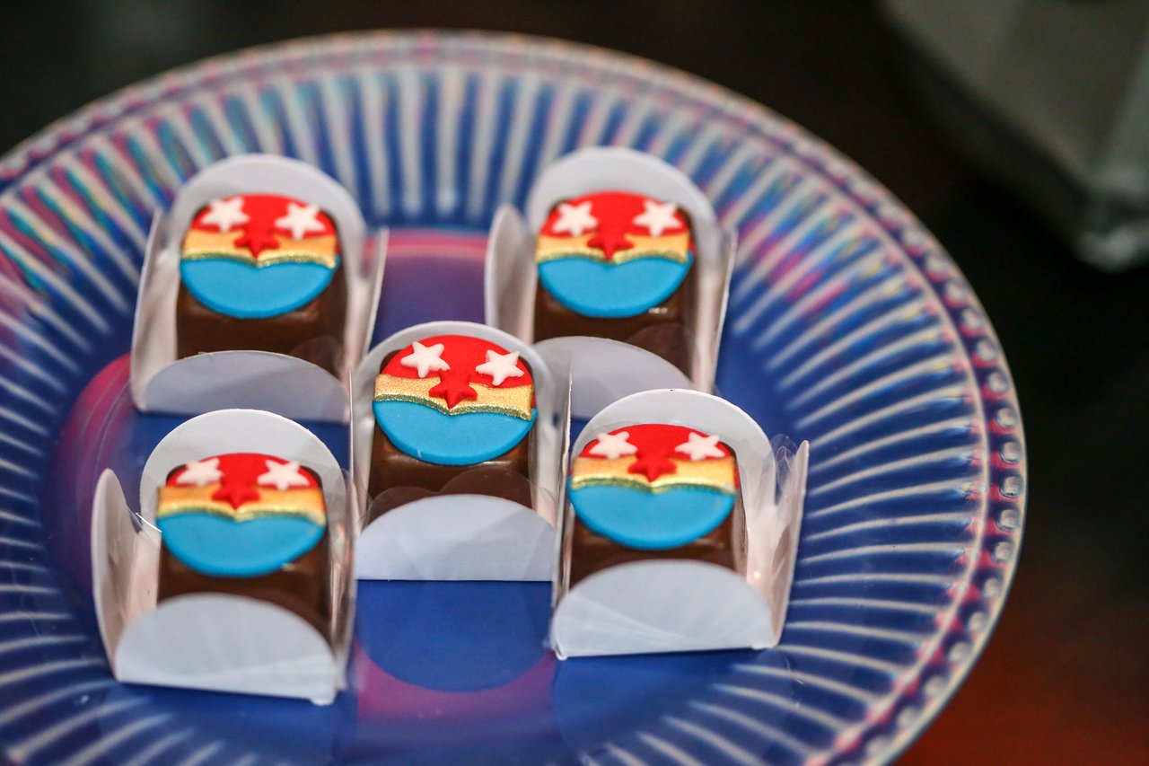A vibrant close-up of decorated chocolates on a patterned plate, perfect for festive occasions.