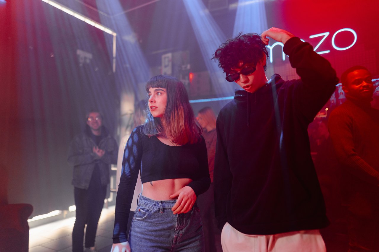 Vibrant nightlife scene in a nightclub with young adults enjoying music and dancing.