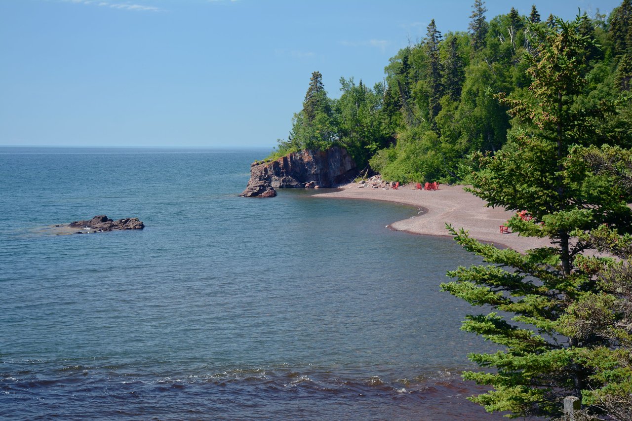 Beautiful view of Lake Superior's rocky shores and dense greenery in Lutsen, Minnesota.