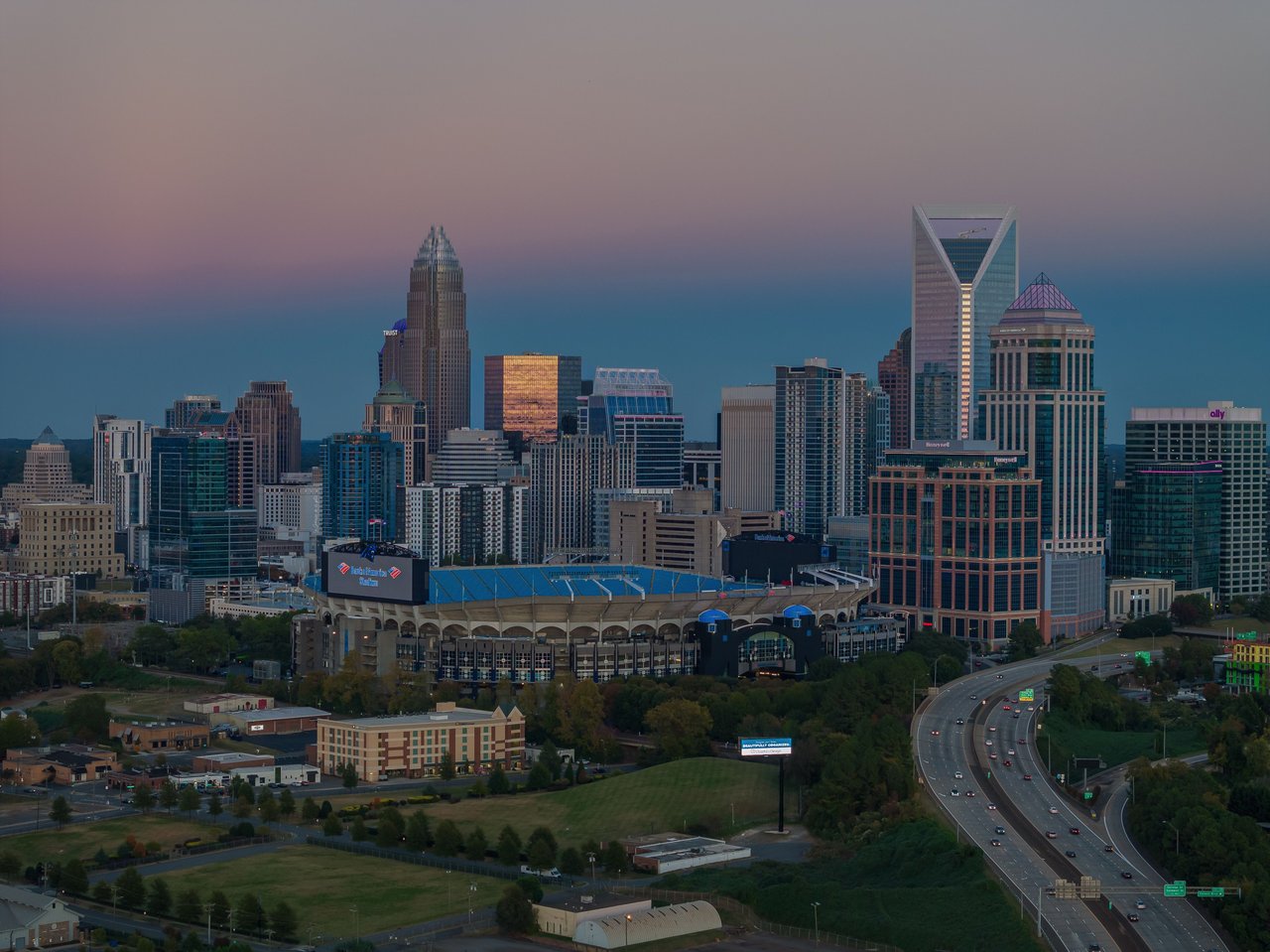 Aerial view of Charlotte skyline and Bank of America Stadium at dusk, North Carolina, USA.