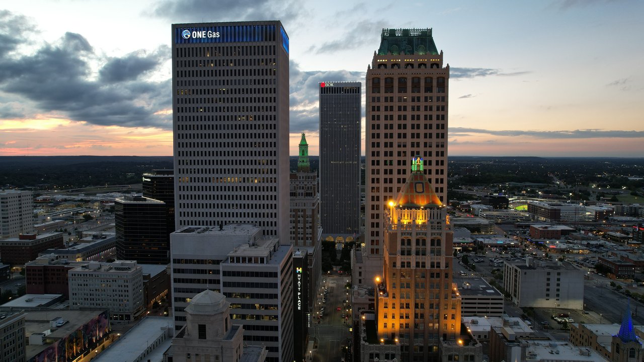 Explore Tulsa's downtown skyline at twilight with stunning architecture and vibrant evening lights.
