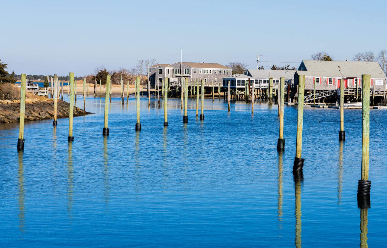 Tranquil waterfront scene with piers and houses in Massachusetts, USA.