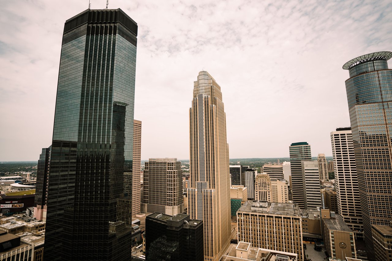 Aerial view of Minneapolis skyline featuring Wells Fargo Center and other skyscrapers.
