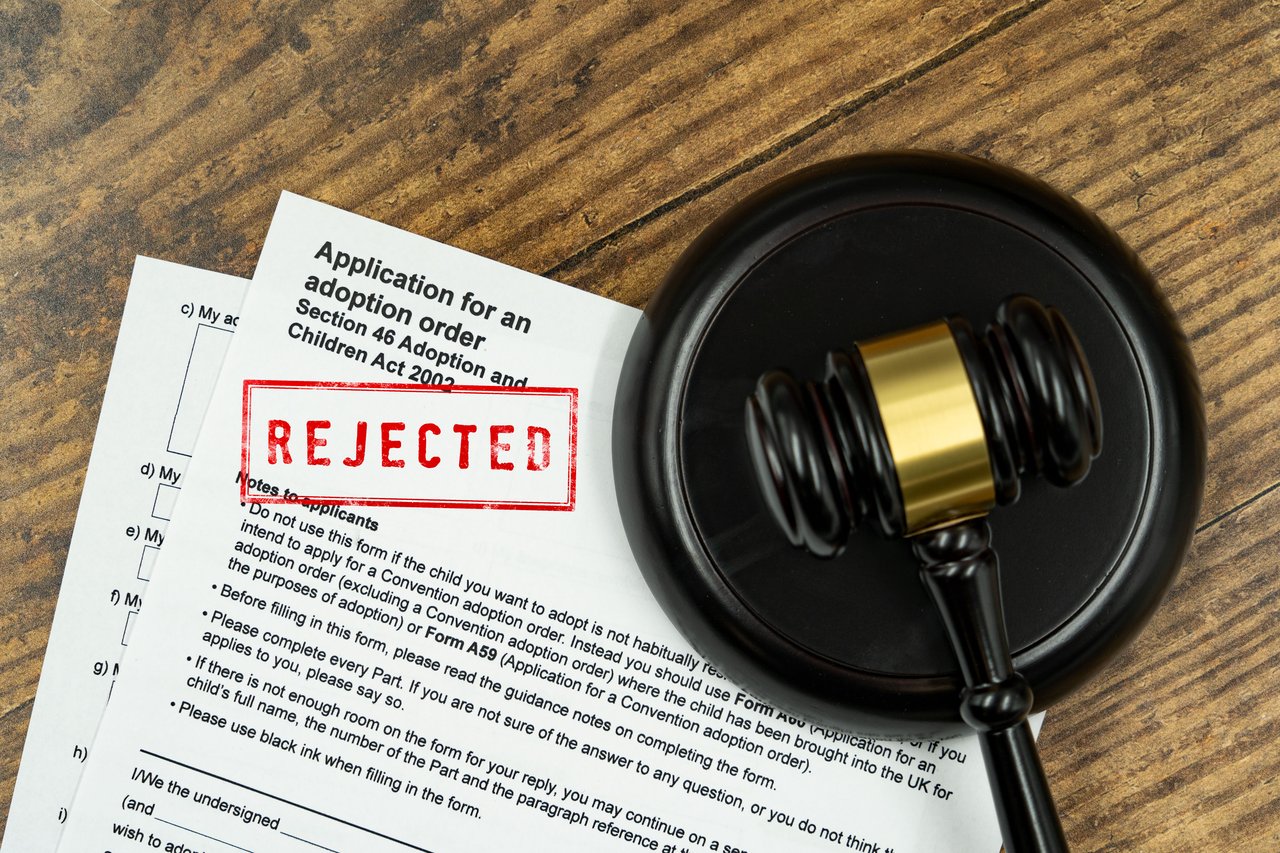 A court gavel placed on top of some adoption forms placed on a wooden background. This picture is completely free to use under creative commons attribution licensing, so we do ask that if used to atta
